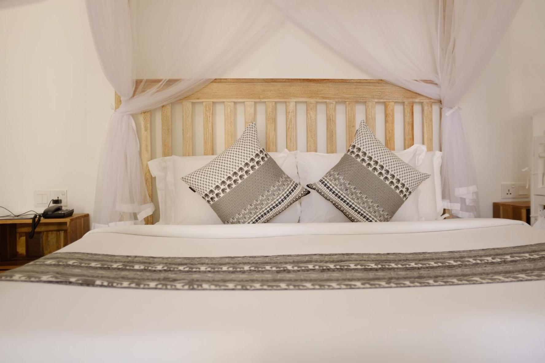 Nivadoo Resort Sigiriya Quarto foto A bed with a mosquito net